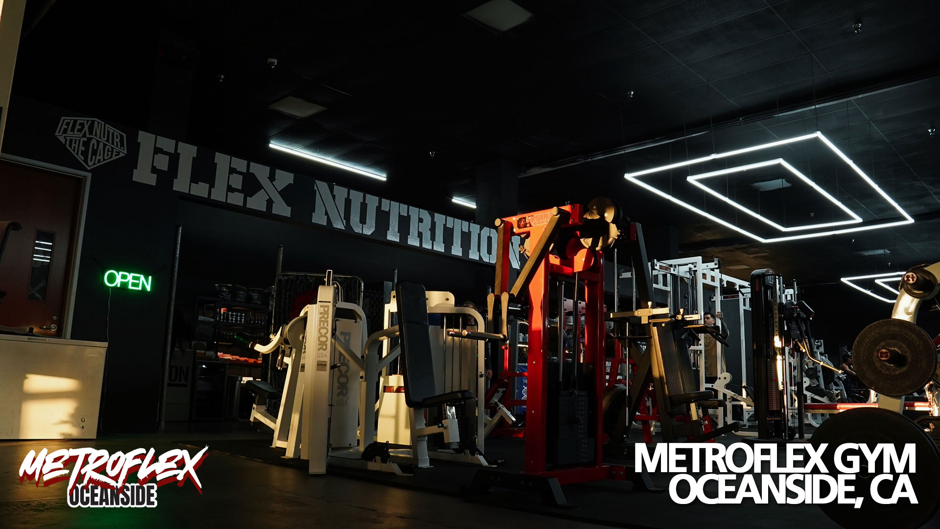 Plate-loaded machines under the ceiling lights at MetroFlex Oceanside.